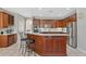 Spacious kitchen featuring dark wood cabinetry, stainless steel appliances, white countertops, and a breakfast bar at 504 Sonata Ct, Winter Springs, FL 32708