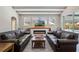 Inviting living room showcasing hardwood floors, a sleek fireplace, and large windows overlooking a screened-in pool area at 504 Sonata Ct, Winter Springs, FL 32708