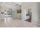 Spacious living room features neutral tile flooring, coffered ceilings, and glass sliding doors to outdoor pool at 504 Sonata Ct, Winter Springs, FL 32708