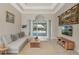 Comfortable living room with neutral tones, recessed lighting, stylish decor, and a view of the pool area at 504 Sonata Ct, Winter Springs, FL 32708