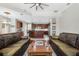 Spacious living room featuring dark wood floors, dual leather sofas, and direct access to the kitchen area at 504 Sonata Ct, Winter Springs, FL 32708