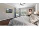 Spacious main bedroom features hardwood floors, a ceiling fan, and sliding glass door to enjoy the view at 504 Sonata Ct, Winter Springs, FL 32708