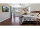 Spacious main bedroom boasts hardwood floors, a ceiling fan, and a TV for relaxing after a long day at 504 Sonata Ct, Winter Springs, FL 32708