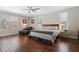 Spacious main bedroom boasts hardwood floors, a ceiling fan, and windows that provide natural light at 504 Sonata Ct, Winter Springs, FL 32708