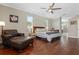 Large main bedroom featuring dark wood floors, windows, a ceiling fan, and a leather seating area at 504 Sonata Ct, Winter Springs, FL 32708