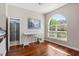 Inviting office featuring hardwood floors, an arched window providing natural light, and access to a shower room at 504 Sonata Ct, Winter Springs, FL 32708