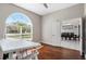 Well-lit office space with hardwood floors, a large arched window, and open access to the dining area at 504 Sonata Ct, Winter Springs, FL 32708