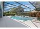 Relaxing in-ground pool with a screened enclosure and beautifully landscaped backyard at 504 Sonata Ct, Winter Springs, FL 32708