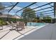 Private screened-in pool area with outdoor seating, perfect for entertaining and relaxation at 504 Sonata Ct, Winter Springs, FL 32708