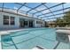 Backyard pool and spa with an outdoor dining set and steps leading into the water at 504 Sonata Ct, Winter Springs, FL 32708