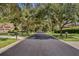 Picturesque tree-lined street with well-maintained homes, creating a welcoming and charming neighborhood setting at 504 Sonata Ct, Winter Springs, FL 32708