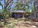 The backyard features a covered porch and plenty of shade at 511 Terrier Way, New Smyrna Beach, FL 32168