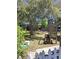 Large backyard with patio area, utility shed, and beautiful landscaping and mature trees at 511 Terrier Way, New Smyrna Beach, FL 32168