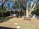 Charming backyard featuring a cozy outdoor structure, a picnic table, and mature trees offering ample shade at 511 Terrier Way, New Smyrna Beach, FL 32168