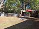 The backyard features a covered cooking area with a corrugated metal fence at 511 Terrier Way, New Smyrna Beach, FL 32168