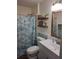 Bathroom with shower, stylish mirror, and wall shelves at 511 Terrier Way, New Smyrna Beach, FL 32168