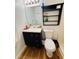 Bathroom with black vanity, framed mirror, and white toilet at 511 Terrier Way, New Smyrna Beach, FL 32168