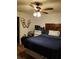 Bedroom with wood floors, ceiling fan, and dark wood bedroom set at 511 Terrier Way, New Smyrna Beach, FL 32168