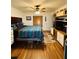 Bedroom with wood floors, ceiling fan, and decorative Southwestern-style bedding at 511 Terrier Way, New Smyrna Beach, FL 32168