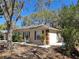 Well-maintained single story home with a side view showing neat landscaping and driveway at 511 Terrier Way, New Smyrna Beach, FL 32168