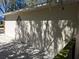 View of exterior wall with diamond design feature and tree shadows at 511 Terrier Way, New Smyrna Beach, FL 32168