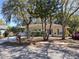 Charming single-story home with a well-maintained lawn and mature trees providing shade at 511 Terrier Way, New Smyrna Beach, FL 32168