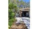 View of the garage, showing a glimpse inside and a pathway with lush greenery at 511 Terrier Way, New Smyrna Beach, FL 32168