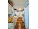 Galley kitchen with wood countertops, white cabinets, and stainless steel appliances at 511 Terrier Way, New Smyrna Beach, FL 32168