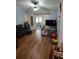 Spacious living room with vaulted ceilings, sliding door to patio, and wood-look floors at 511 Terrier Way, New Smyrna Beach, FL 32168
