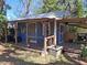 This backyard outbuilding is painted blue and has a covered porch at 511 Terrier Way, New Smyrna Beach, FL 32168