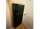 Home interior showing a large, black Stack-On safe next to a white door at 511 Terrier Way, New Smyrna Beach, FL 32168