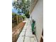 Side yard with a walkway leading to a white picket fence, showing the yard's layout and potential at 511 Terrier Way, New Smyrna Beach, FL 32168