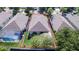 Drone eye view of house nestled between neighbors with fenced in backyard with stone patio at 5123 Santa Ana Dr, Orlando, FL 32837