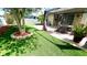 Picturesque backyard featuring artificial grass, stone patio, and gazebo for a relaxing outdoor retreat at 5123 Santa Ana Dr, Orlando, FL 32837