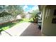 Serene backyard showcasing a brick patio, artificial turf, and a charming white fence for added privacy at 5123 Santa Ana Dr, Orlando, FL 32837