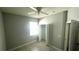 Bedroom offering a closet with folding doors, ceiling fan, window and tile floor at 5123 Santa Ana Dr, Orlando, FL 32837
