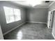 Spacious bedroom features modern tiled floors, a ceiling fan and a window for natural light at 5123 Santa Ana Dr, Orlando, FL 32837