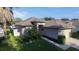 Aerial view of a cozy single-Gathering home featuring lush landscaping and a neatly maintained lawn at 5123 Santa Ana Dr, Orlando, FL 32837