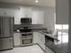 Modern kitchen with stainless steel appliances and granite countertops at 5123 Santa Ana Dr, Orlando, FL 32837