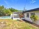 Well-maintained home exterior with a screened-in patio and a view of the swimming pool at 533 Baxter St, Orlando, FL 32806