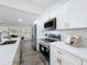 Modern kitchen with white cabinetry, stainless steel appliances, and quartz countertops at 533 Baxter St, Orlando, FL 32806