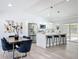 Modern kitchen with stainless steel appliances, a breakfast bar, and easy access to dining and living areas at 533 Baxter St, Orlando, FL 32806