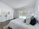 Inviting main bedroom with cozy bedding, modern decor, and a view of the sparkling outdoor pool at 533 Baxter St, Orlando, FL 32806
