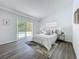 Relaxing main bedroom features soft bedding and sliding glass doors leading to a refreshing outdoor pool at 533 Baxter St, Orlando, FL 32806