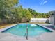 Sparkling swimming pool with concrete decking surrounded by lush greenery, perfect for summer fun at 533 Baxter St, Orlando, FL 32806