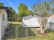 Spacious storage shed located in the backyard with a chain-link fence at 533 Baxter St, Orlando, FL 32806