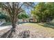 A single-story home with a carport featuring a boat on a trailer at 5386 Mustang Way, Orlando, FL 32810