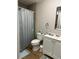 Cozy bathroom featuring a vanity cabinet, toilet, and shower with a blue-themed curtain at 58 Magnolia Dr, Debary, FL 32713