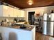 Functional kitchen featuring a stainless steel refrigerator and granite countertops at 58 Magnolia Dr, Debary, FL 32713