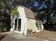 Exterior view of a white storage shed with a large window and ample space for storage or hobbies at 58 Magnolia Dr, Debary, FL 32713